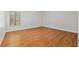 Bright, empty bedroom with hardwood floors and a window overlooking the front yard at 3230 Se 45Th St, Ocala, FL 34480