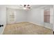 Clean bedroom featuring carpet, neutral walls, and windows with light curtains at 3230 Se 45Th St, Ocala, FL 34480