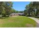 Lovely front yard with mature trees and curved driveway leading to home at 3230 Se 45Th St, Ocala, FL 34480