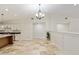 Open-concept kitchen and living area with tile floors and white walls, perfect for entertaining at 3230 Se 45Th St, Ocala, FL 34480