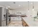 Modern kitchen with white cabinets, stainless steel appliances, wood countertop, and island with granite countertop at 3230 Se 45Th St, Ocala, FL 34480