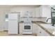 Traditional white kitchen featuring granite countertops and stainless appliances at 3230 Se 45Th St, Ocala, FL 34480