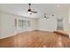 Bright living room showcasing hardwood floors, a large bay window, and dual ceiling fans for added comfort at 3230 Se 45Th St, Ocala, FL 34480