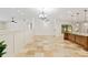 Spacious living room area showcasing tiled floors and seamless open-concept design, complemented by modern lighting at 3230 Se 45Th St, Ocala, FL 34480