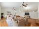 Bright living room featuring hardwood floors, ceiling fans, and an open floor plan at 3230 Se 45Th St, Ocala, FL 34480