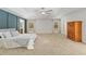Bright main bedroom with vaulted ceiling, walk in closet, ensuite bathroom, and two large windows at 3230 Se 45Th St, Ocala, FL 34480