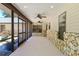 Inviting screened patio with ceiling fans, stone accents, and neutral flooring at 3230 Se 45Th St, Ocala, FL 34480