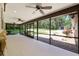 Spacious screened-in patio featuring ceiling fans and a view of the backyard at 3230 Se 45Th St, Ocala, FL 34480