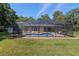 Exterior view of screen-enclosed pool and spacious yard at 3230 Se 45Th St, Ocala, FL 34480