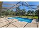 Screened-in pool area with tan brick pavers offers an ideal place to relax and enjoy the outdoors at 3230 Se 45Th St, Ocala, FL 34480