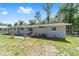 The backyard features well-maintained lawn, ideal for outdoor enjoyment and Gathering activities at 3810 Sw 5Th Ave, Ocala, FL 34471