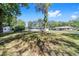 Large backyard with mature trees, a well manicured lawn, and partial fence-line in a residential neighborhood at 3810 Sw 5Th Ave, Ocala, FL 34471