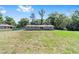 The backyard features well-maintained lawn, ideal for outdoor enjoyment and Gathering activities at 3810 Sw 5Th Ave, Ocala, FL 34471