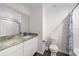 Bathroom featuring granite countertop vanity, mirror, toilet, and shower with curtain at 3810 Sw 5Th Ave, Ocala, FL 34471