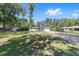 Charming single-story home featuring a long driveway and a well-manicured lawn with mature trees at 3810 Sw 5Th Ave, Ocala, FL 34471