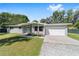 Charming gray brick home featuring a well-manicured lawn, tidy landscaping and a bright-colored front door at 3810 Sw 5Th Ave, Ocala, FL 34471