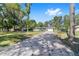 Charming single-story home featuring a long driveway and a well-manicured lawn with mature trees at 3810 Sw 5Th Ave, Ocala, FL 34471