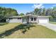 Charming single story home with a light gray brick exterior, teal front door, and well manicured lawn at 3810 Sw 5Th Ave, Ocala, FL 34471