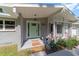Charming front porch with a mint green door, tasteful decorations, and welcoming mats at 3810 Sw 5Th Ave, Ocala, FL 34471