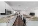 Well-lit kitchen with stainless steel appliances, granite countertops, white cabinetry, and sleek dark wood floors at 3810 Sw 5Th Ave, Ocala, FL 34471