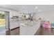 Open kitchen showcasing granite countertops, white cabinets, and stainless appliances at 3810 Sw 5Th Ave, Ocala, FL 34471