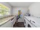 Functional laundry room with modern appliances, a countertop, and ample storage space at 3810 Sw 5Th Ave, Ocala, FL 34471