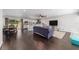 Open-concept living space with dark hardwood floors connecting the dining area, kitchen, and living room at 3810 Sw 5Th Ave, Ocala, FL 34471