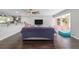 Open-concept living room featuring sleek hardwood floors and a seamless flow to the kitchen at 3810 Sw 5Th Ave, Ocala, FL 34471