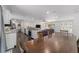 Open-concept living space showcasing a kitchen, dining area, and living room with wood floors and ample natural light at 3810 Sw 5Th Ave, Ocala, FL 34471