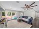Bright living room with large windows, plush seating, and a stylish ceiling fan for ultimate comfort at 3810 Sw 5Th Ave, Ocala, FL 34471