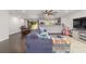 Open-concept living room with kitchen view, dining area, and modern ceiling fan at 3810 Sw 5Th Ave, Ocala, FL 34471