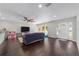 Spacious living room with fan, large TV, play area, and front door entrance at 3810 Sw 5Th Ave, Ocala, FL 34471