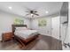 Spacious main bedroom featuring hardwood floors, a modern ceiling fan, and bright windows at 3810 Sw 5Th Ave, Ocala, FL 34471