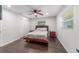 The main bedroom features hard wood floors, a ceiling fan and two windows at 3810 Sw 5Th Ave, Ocala, FL 34471