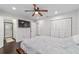 Main bedroom features a ceiling fan, large windows, and access to the ensuite bathroom at 3810 Sw 5Th Ave, Ocala, FL 34471