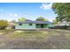 The large backyard offers plenty of room, accentuated by mature trees and the home's exterior at 3834 Se 9Th Pl, Ocala, FL 34471
