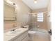 Bright bathroom with a shower-tub combo, vanity sink and gold fixtures at 3834 Se 9Th Pl, Ocala, FL 34471