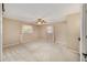 Cozy bedroom with plush carpeting, two bright windows, and ceiling fan at 3834 Se 9Th Pl, Ocala, FL 34471