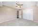 Bedroom featuring neutral carpet, closet, and a ceiling fan at 3834 Se 9Th Pl, Ocala, FL 34471