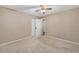 Comfortable bedroom with neutral tones, closet, and ceiling fan at 3834 Se 9Th Pl, Ocala, FL 34471