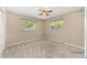 Bright bedroom with two large windows, carpeting, and ceiling fan at 3834 Se 9Th Pl, Ocala, FL 34471
