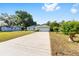 Charming one-story home with green exterior, white garage door, and long concrete driveway at 3834 Se 9Th Pl, Ocala, FL 34471