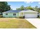 A beautifully maintained home features a well-groomed lawn, tasteful landscaping, and a convenient two-car garage at 3834 Se 9Th Pl, Ocala, FL 34471