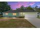 Charming home featuring a well-manicured lawn and inviting curb appeal at dusk at 3834 Se 9Th Pl, Ocala, FL 34471