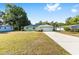 Attractive single-story home boasts a well-kept lawn, complemented by a long driveway and attached garage at 3834 Se 9Th Pl, Ocala, FL 34471