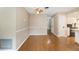 Open-concept living room with wood floors, ceiling fan, and access to the kitchen at 3834 Se 9Th Pl, Ocala, FL 34471