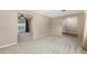 Spacious living room with neutral carpet, ceiling fan and sliding glass door to backyard at 3834 Se 9Th Pl, Ocala, FL 34471