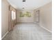 Bright, carpeted living room featuring neutral paint, and a picturesque landscape mural at 3834 Se 9Th Pl, Ocala, FL 34471