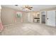 Large main bedroom featuring neutral carpet, a ceiling fan and a vanity area at 3834 Se 9Th Pl, Ocala, FL 34471
