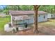 Backyard featuring a cozy patio area, ideal for outdoor grilling and enjoying the peaceful surroundings at 4180 W Anthony Rd, Ocala, FL 34475